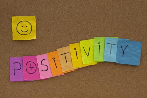 Positivity spelled on Post It notes