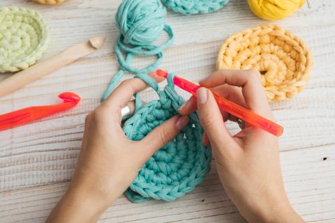 image of two hands crocheting