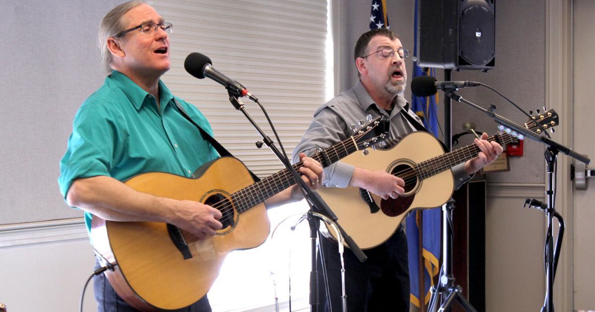 2 men playing guitar